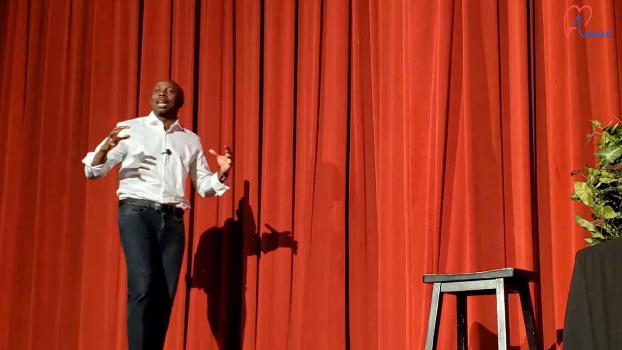 Amas on stage with red background
